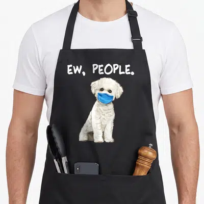 Bichon dog face apron - White cartoon dog in blue mask under text ew people — shown on a black cotton canvas apron against a white background