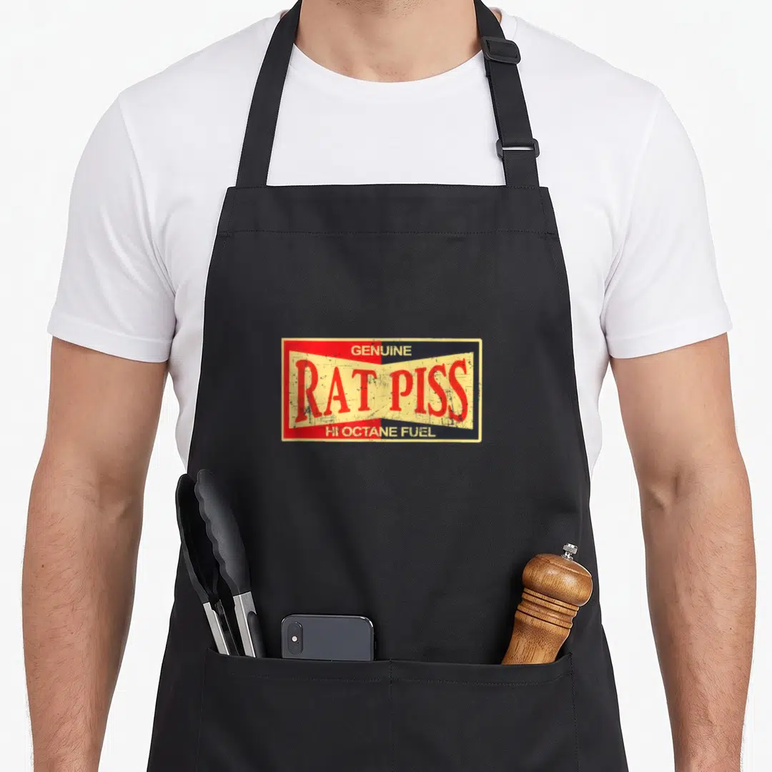 Rat fuel apron - Rectangular label with GENUINE RAT PISS HI OCTANE FUEL text in red yellow and black distressed style — shown on a black cotton canvas apron against a white background
