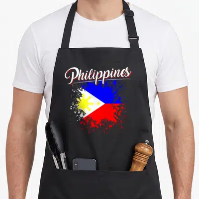 Philippine flag pride apron - Philippines script text over splatter-style Philippine flag in blue red white and yellow — shown on a black cotton canvas apron against a white background