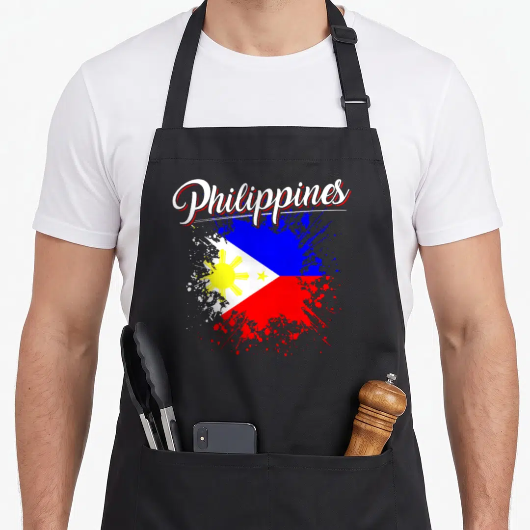 Philippine flag pride apron - Philippines script text over splatter-style Philippine flag in blue red white and yellow — shown on a black cotton canvas apron against a white background