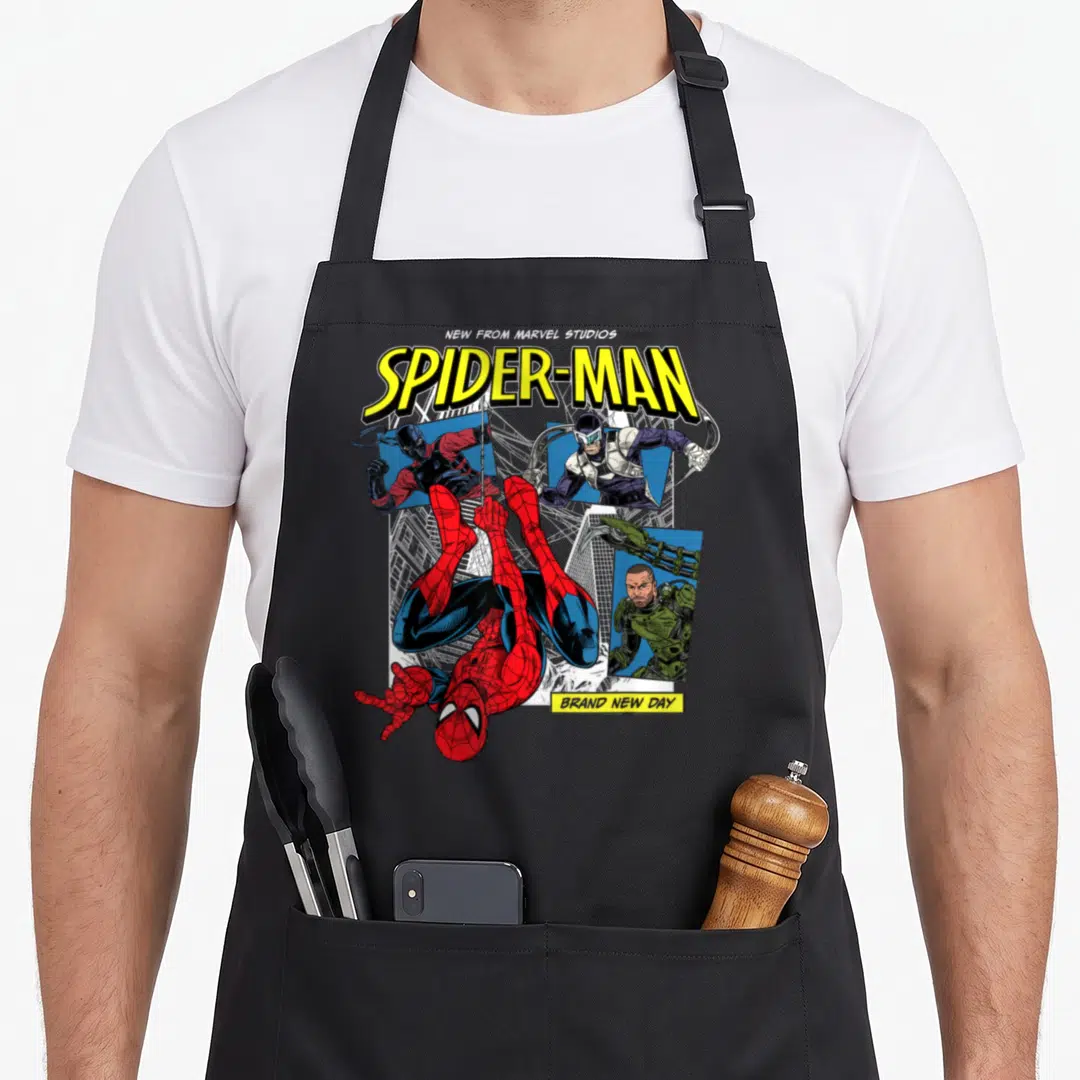 Scorpion tarantula apron - Spider-Man hanging upside down over three villain panels with Brand New Day text — shown on a black cotton canvas apron against a white background