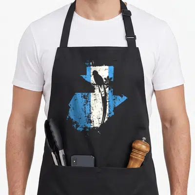 Chapin guatemalan aprons - Black bird silhouette perched on branch over distressed blue and white map of Guatemala — shown on a black cotton canvas apron against a white background