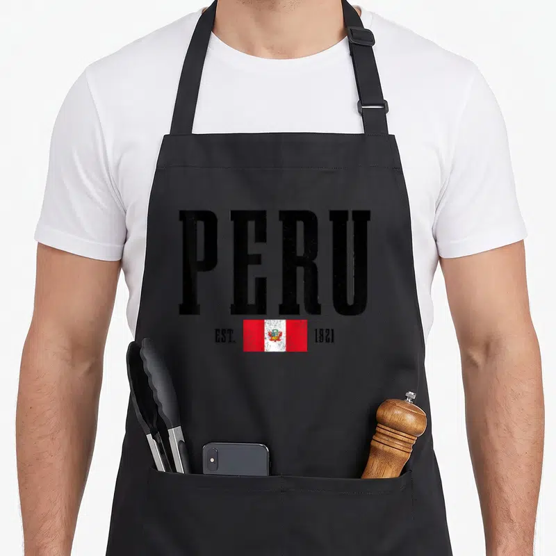 Peru est pride apron - Distressed black PERU text above red white flag flanked by EST 1821 — shown on a black cotton canvas apron against a white background