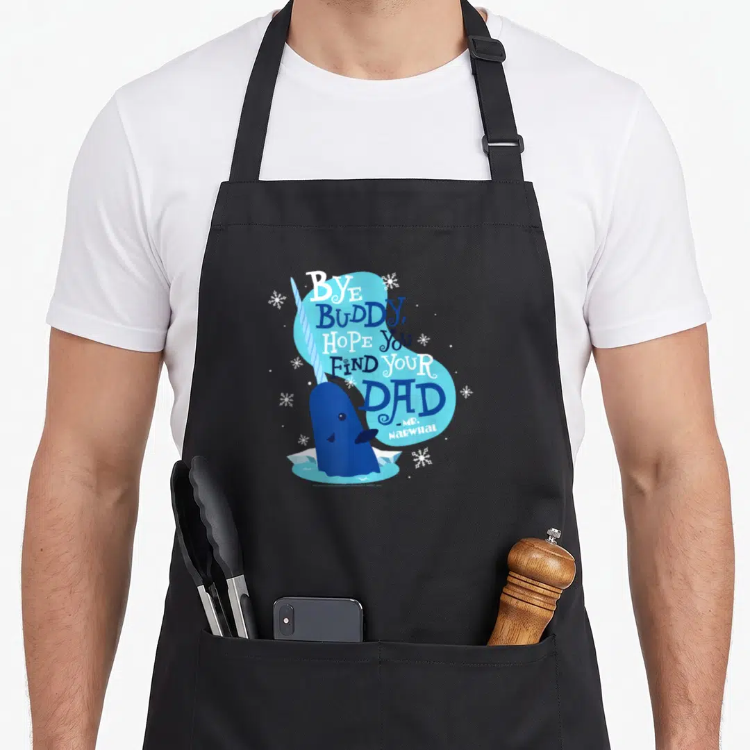 Bye christmas elf apron - Blue cartoon narwhal with Bye Buddy Hope You Find Your Dad text and snowflakes — shown on a black cotton canvas apron against a white background