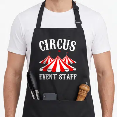 Event staff aprons - Three red and white striped circus tents with CIRCUS and EVENT STAFF text — shown on a black cotton canvas apron against a white background