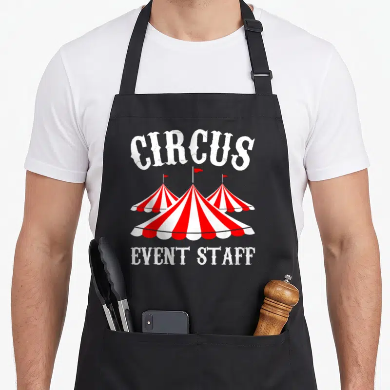 Event staff aprons - Three red and white striped circus tents with CIRCUS and EVENT STAFF text — shown on a black cotton canvas apron against a white background