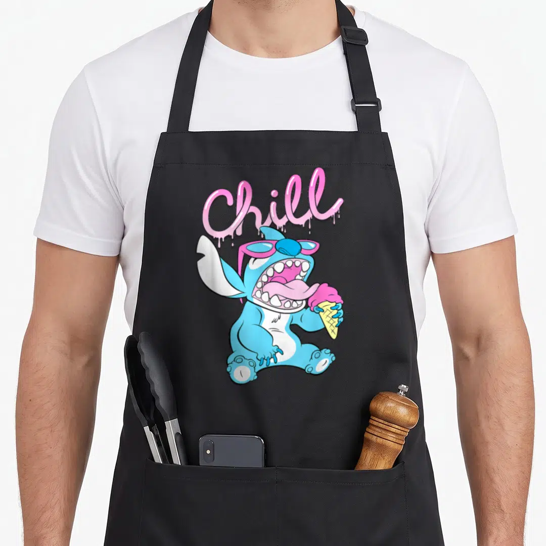 Neon ice cream apron - Blue cartoon character with pink sunglasses licking ice cream under dripping Chill text — shown on a black cotton canvas apron against a white background