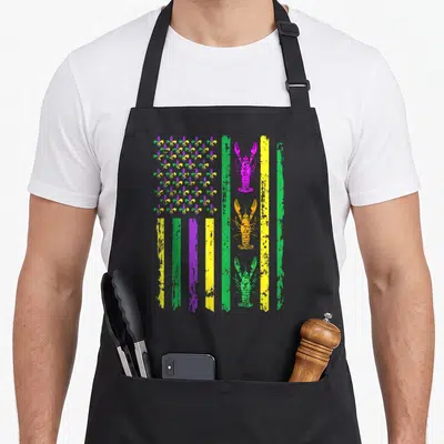 Carnival american flag apron - Distressed flag with purple green yellow fleur-de-lis and three stacked lobsters — shown on a black cotton canvas apron against a white background