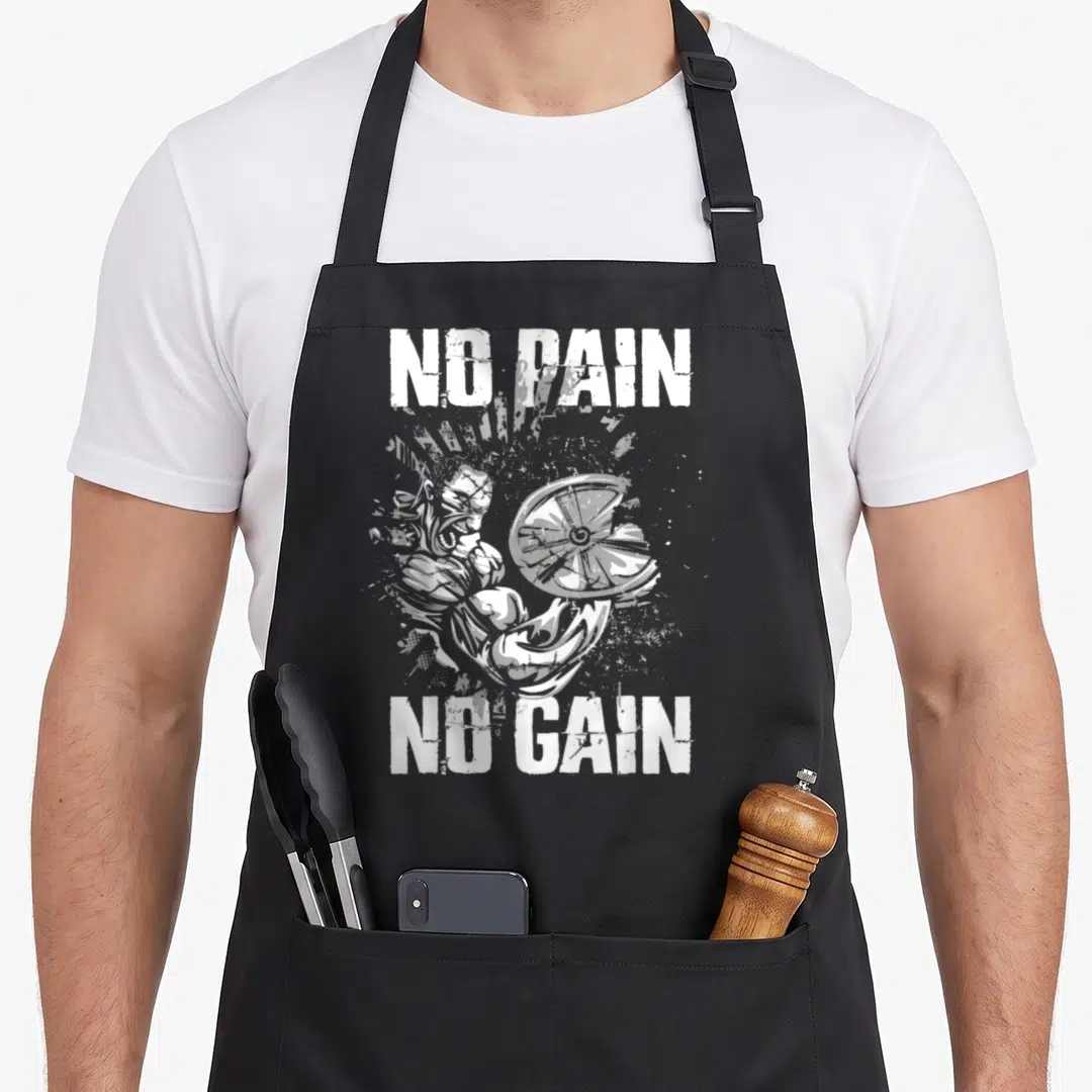 Pain bodybuilding apron - Distressed grey illustration of a bodybuilder holding a weight plate flanked by white text — shown on a black cotton canvas apron against a white background