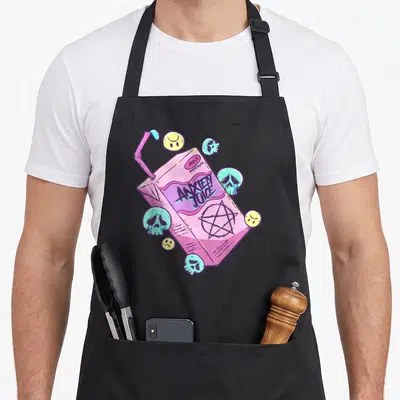 Juice goth apron - Pink juice box with ANXIETY JUICE text, skulls, smiley faces, and a pentagram in pastel colors — shown on a black cotton canvas apron against a white background