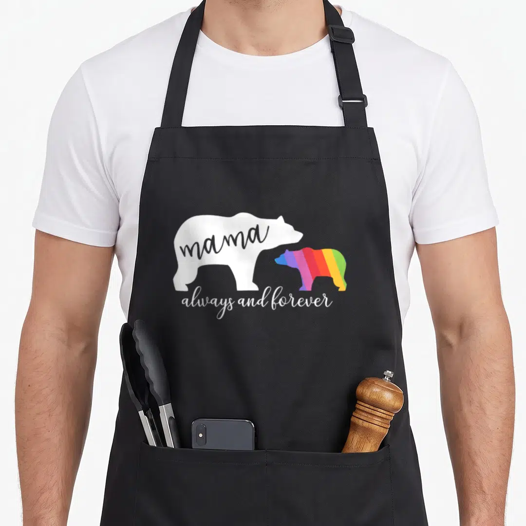 Gay cute bear apron - White bear silhouette with mama text and rainbow striped bear next to always and forever script — shown on a black cotton canvas apron against a white background