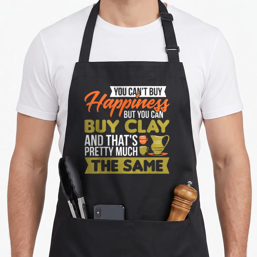 Happiness maker apron - Typography art reading buy clay with three pottery vessels in orange and olive green — shown on a black cotton canvas apron against a white background