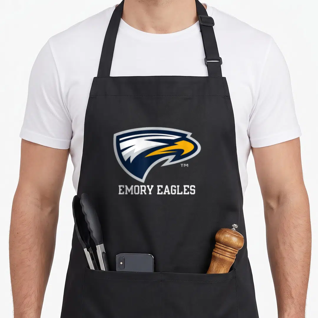 Emory eagles apron - Cartoon eagle head in navy and yellow above white EMORY EAGLES text — shown on a black cotton canvas apron against a white background