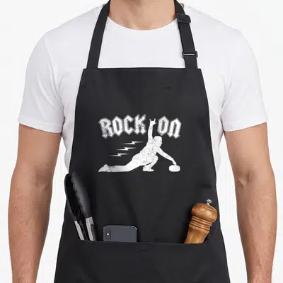 Roll winter apron - White distressed ROCK ON text above curling silhouette with lightning bolts — shown on a black cotton canvas apron against a white background