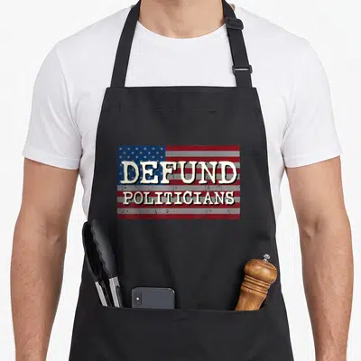 Politician political products online apron - Distressed US flag graphic with cream text reading DEFUND POLITICIANS — shown on a black cotton canvas apron against a white background