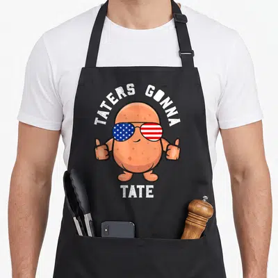 Tate food aprons - Cartoon potato with US flag sunglasses and Taters Gonna Tate text — shown on a black cotton canvas apron against a white background