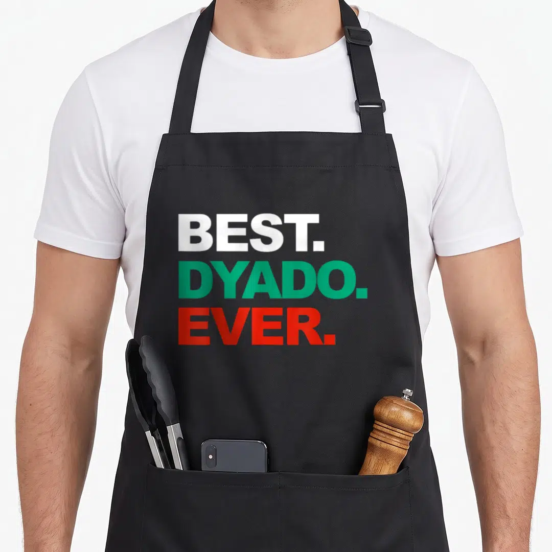 Dyado father day apron - Stacked white green and red text reading BEST DYADO EVER — shown on a black cotton canvas apron against a white background