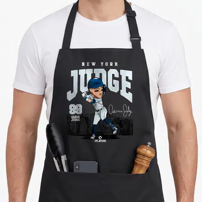 Judge new york apron - Cartoon Aaron Judge batting 99 with New York skyline and signature — shown on a black cotton canvas apron against a white background