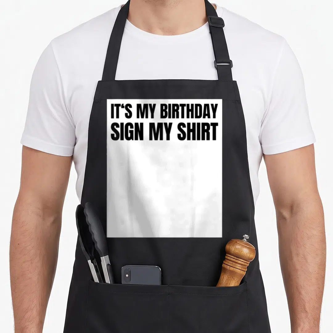 Ice birthday apron - Black text reading IT'S MY BIRTHDAY SIGN MY SHIRT on white background — shown on a black cotton canvas apron against a white background