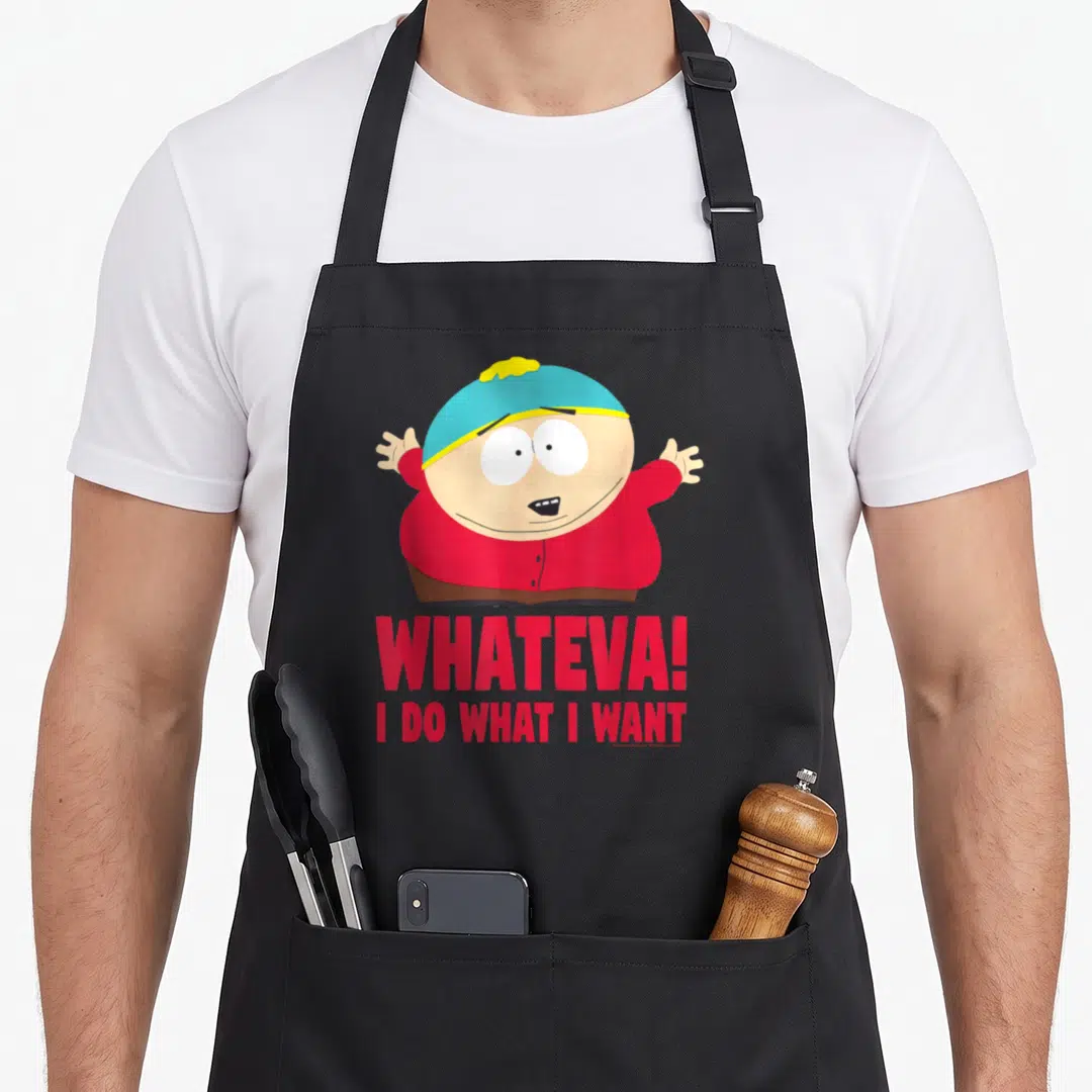 Cartman crew apron - Cartoon character in blue hat and red shirt above red text reading WHATEVA! I DO WHAT I WANT — shown on a black cotton canvas apron against a white background