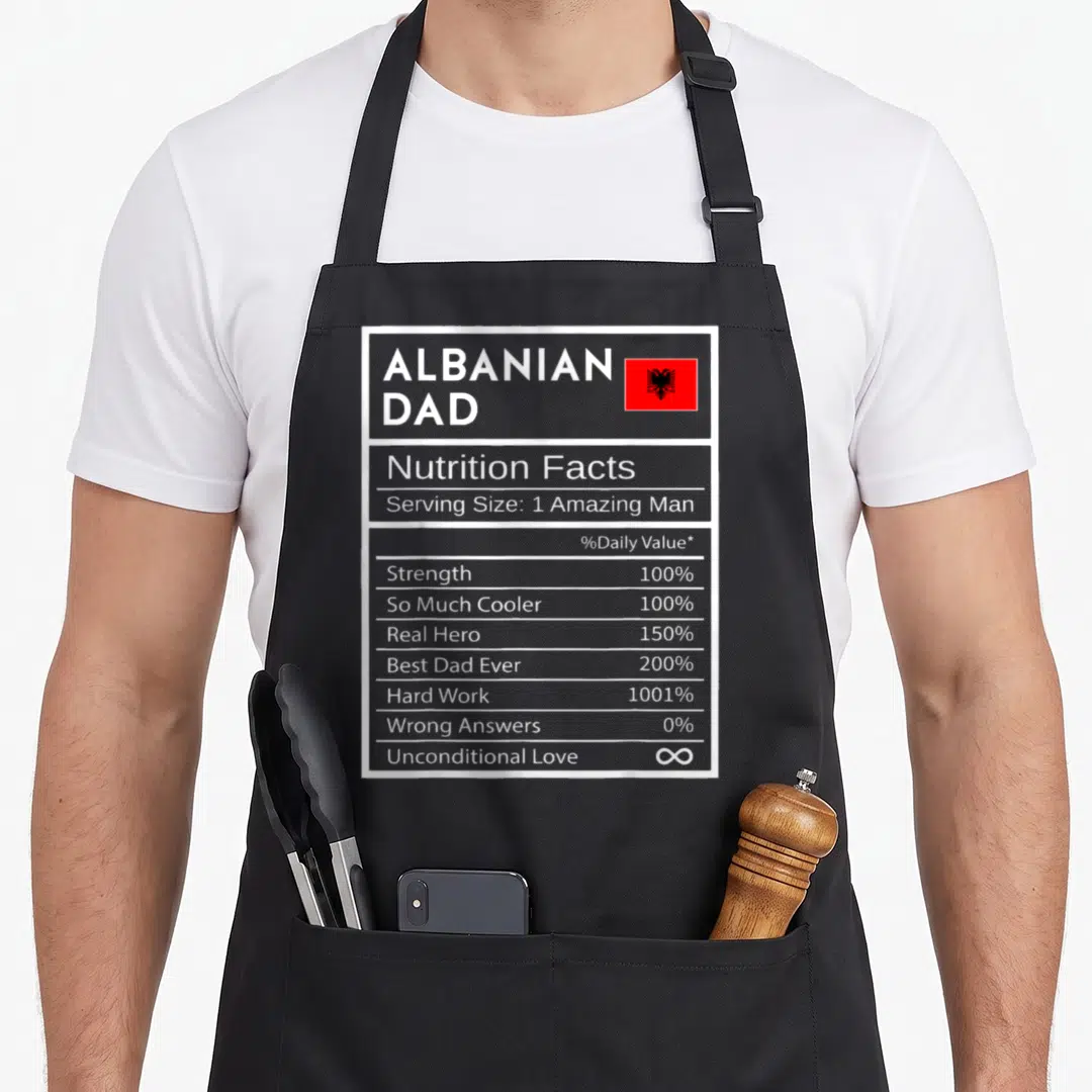 Albanian pride apron - Grey nutrition facts label with Albanian flag and percentages for dad attributes — shown on a black cotton canvas apron against a white background
