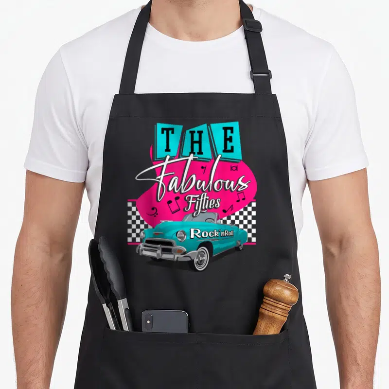 50s hip aprons - The Fabulous Fifties Rock nRoll text with turquoise car and pink graphic on checkerboard background — shown on a black cotton canvas apron against a white background