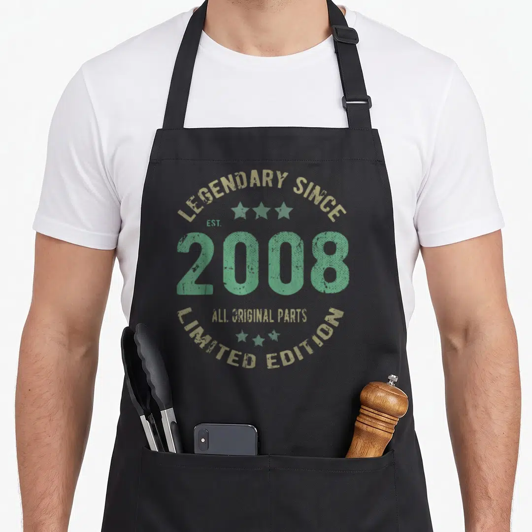 Legend 18th birthday apron - Retro circular text design reading Legendary Since 2008 All Original Parts Limited Edition — shown on a black cotton canvas apron against a white background