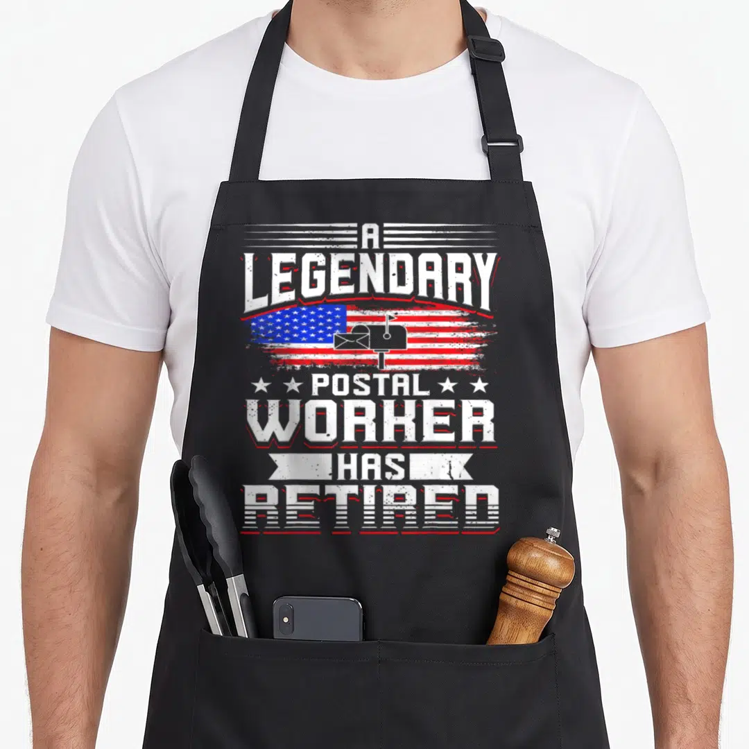 Postal mailman retirement apron - Distressed USA flag with mailbox and A LEGENDARY POSTAL WORKER HAS RETIRED text — shown on a black cotton canvas apron against a white background