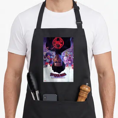 Theatrical animal apron - Upside-down Miles Morales surrounded by Spider-People with ACROSS THE SPIDER-VERSE text above — shown on a black cotton canvas apron against a white background