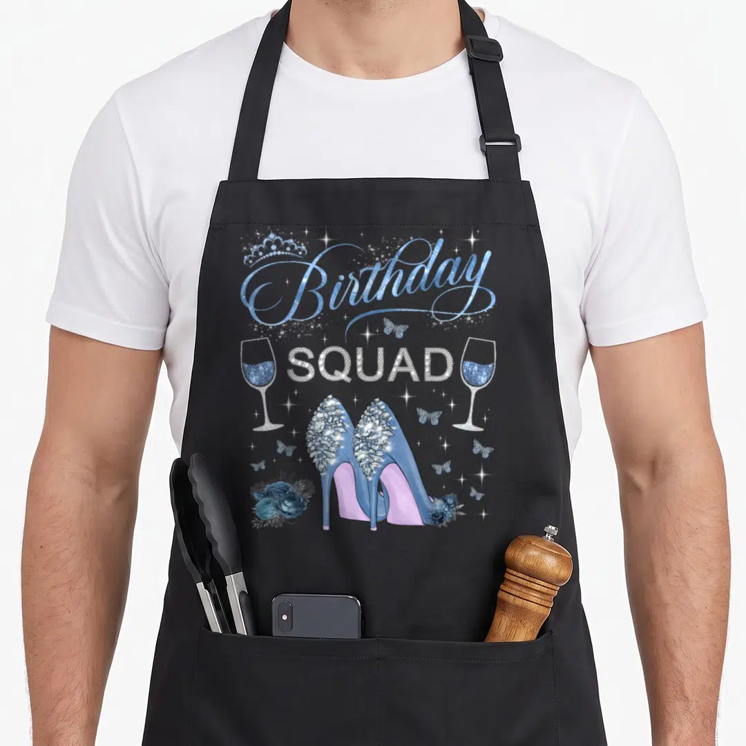 Birthday squad butterfly apron - Blue high heels, rhinestone SQUAD text, wine glasses, and butterflies — shown on a black cotton canvas apron against a white background