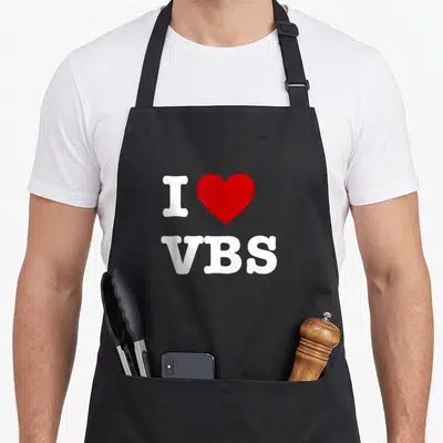 Vacation christian apron - White I letter red heart VBS text on black bib — shown on a black cotton canvas apron against a white background