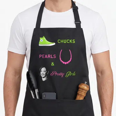 Kamala pretty apron - Lime green sneaker, pink necklace, woman's face, and chucks pearls pretty girls text — shown on a black cotton canvas apron against a white background