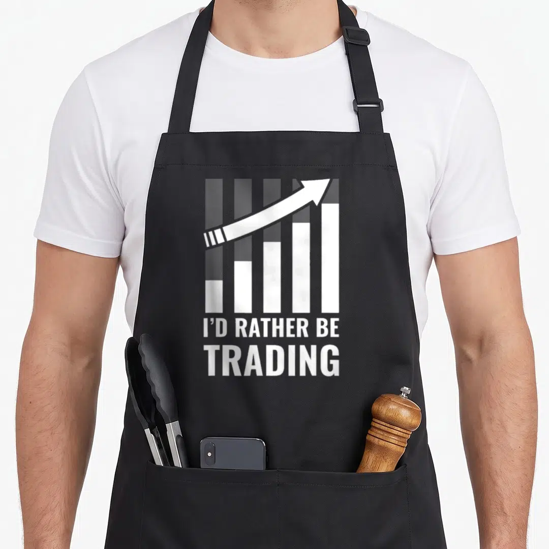 Would stock aprons - White bar chart with upward arrow and text I'D RATHER BE TRADING — shown on a black cotton canvas apron against a white background