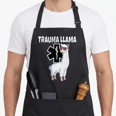 Trauma emt apron - Cartoon llama in sunglasses standing before a black Star of Life with white text above — shown on a black cotton canvas apron against a white background