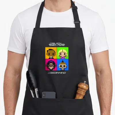 Beginning eyed apron - Four pixel art faces in colored squares with band name and album title text — shown on a black cotton canvas apron against a white background