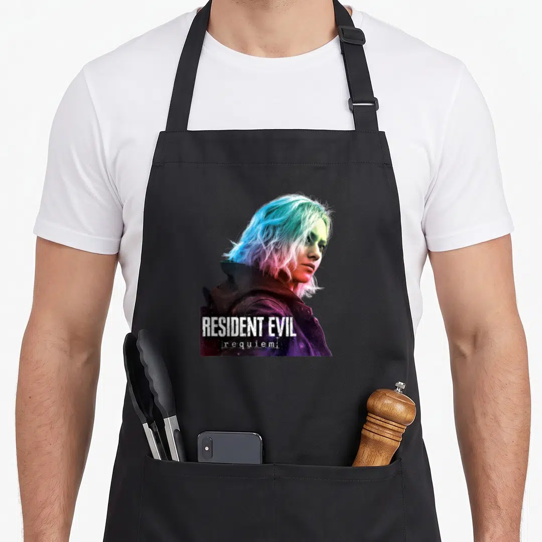 Requiem gaming apron - Woman with blue pink purple hair and white Resident Evil Requiem text overlay — shown on a black cotton canvas apron against a white background