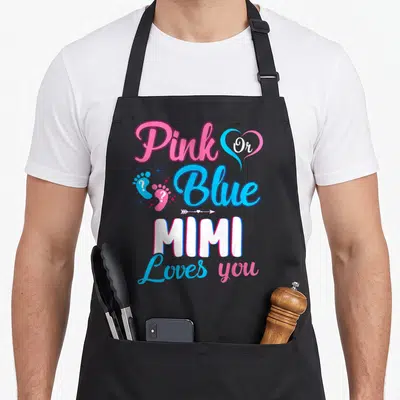 Mimi apron or apron - Pink and blue typography reading Pink Or Blue MIMI Loves you with footprints and stars — shown on a black cotton canvas apron against a white background