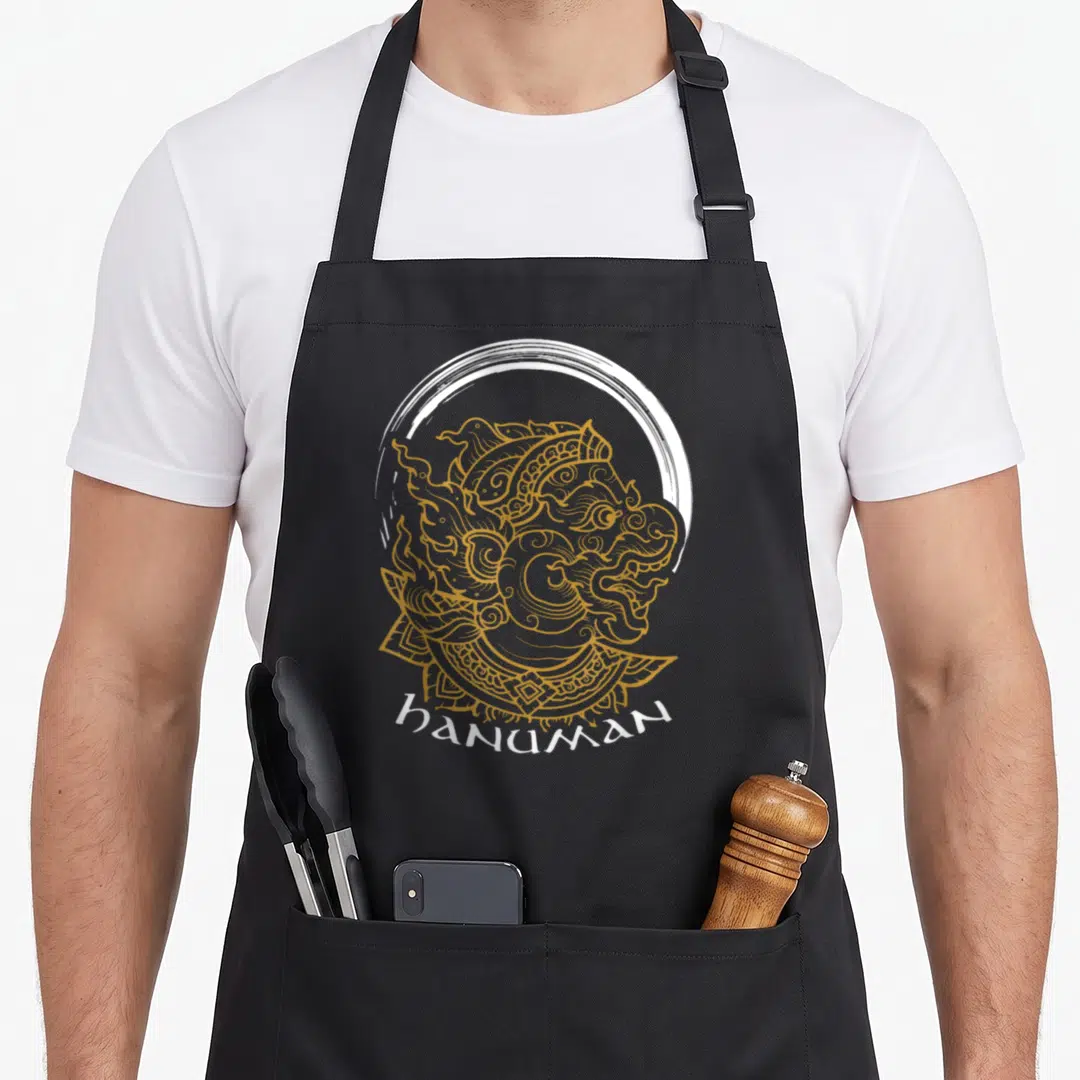 Hindus diwali apron - Gold line art Hanuman head inside white brush circle with text below — shown on a black cotton canvas apron against a white background