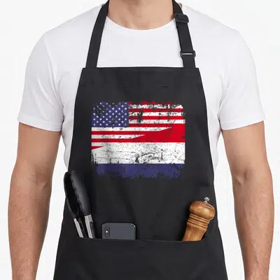Dutch american flag apron - Distressed red white and blue split flag graphic on canvas — shown on a black cotton canvas apron against a white background