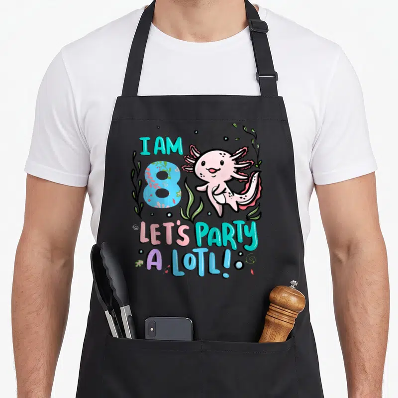 8th axolotl birthday apron - Pink axolotl next to blue number 8 and text I AM 8 LET'S PARTY A LOTL surrounded by teal — shown on a black cotton canvas apron against a white background