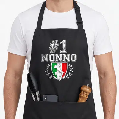 Number italian apron - #1 NONNO text above Italian flag shield with map and laurel wreath in distressed style — shown on a black cotton canvas apron against a white background