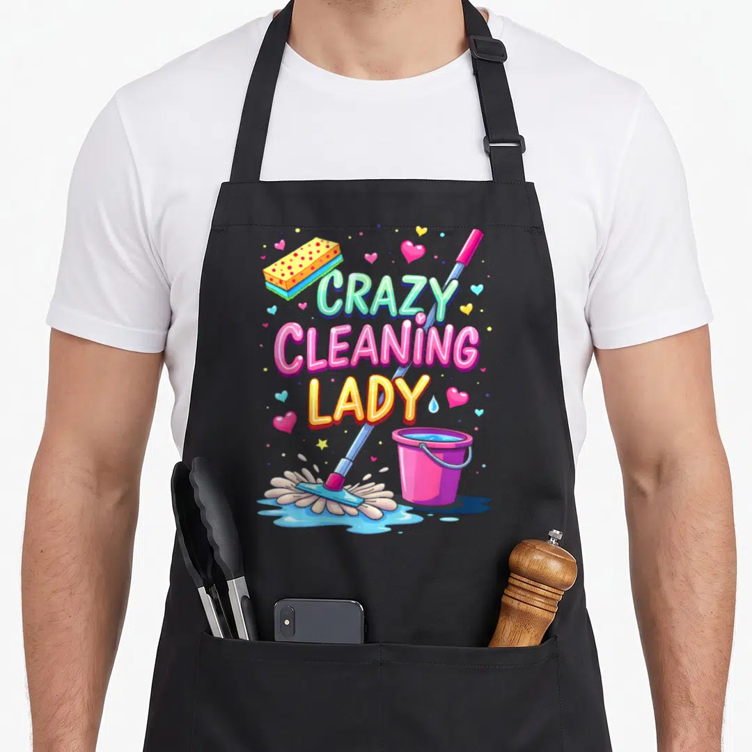 Cleaner housekeeper apron - Stacked Crazy Cleaning Lady text with cartoon mop, pink bucket, yellow sponge, hearts — shown on a black cotton canvas apron against a white background