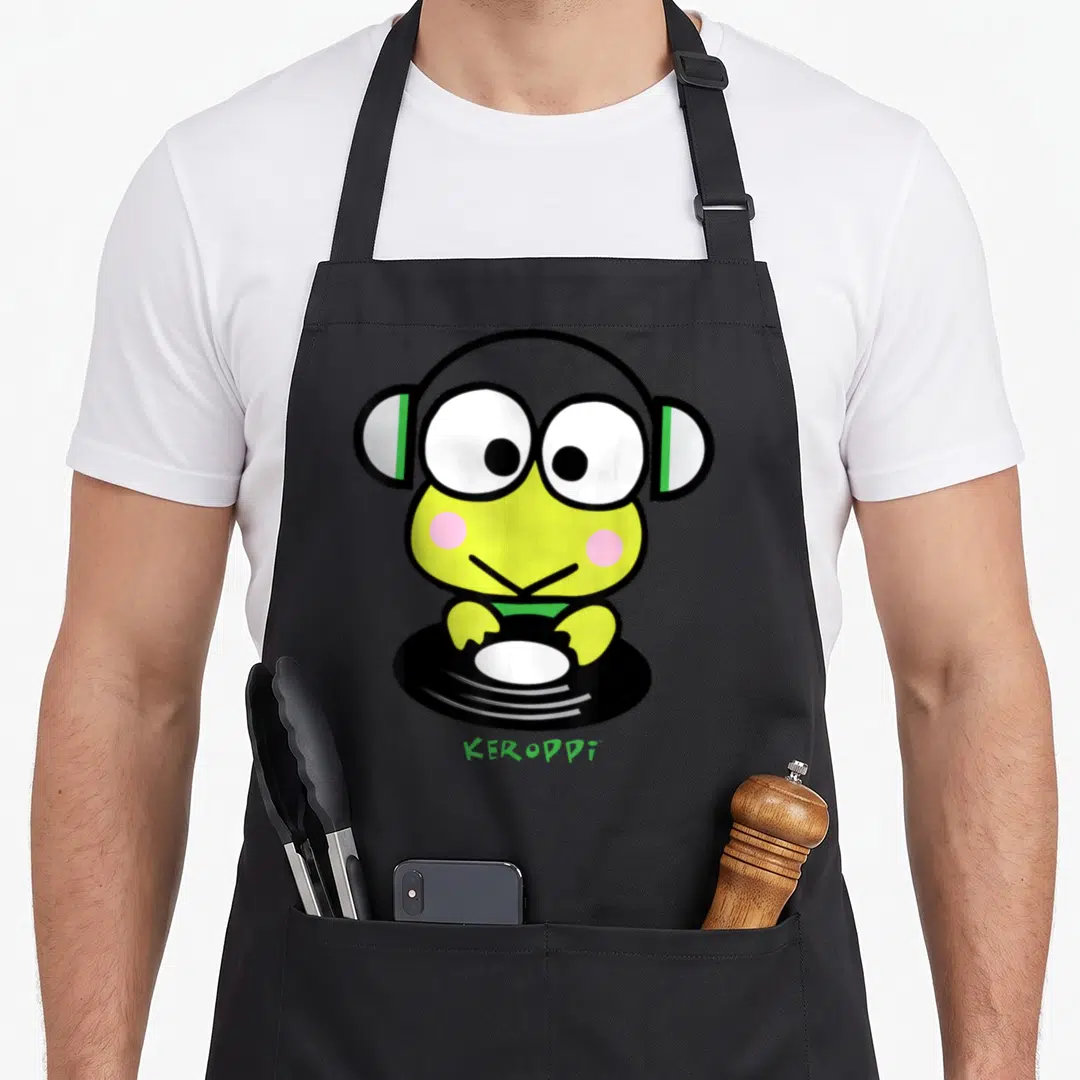 Keroppi spin apron - Lime green frog character wearing headphones above a black turntable with KEROPPI text — shown on a black cotton canvas apron against a white background