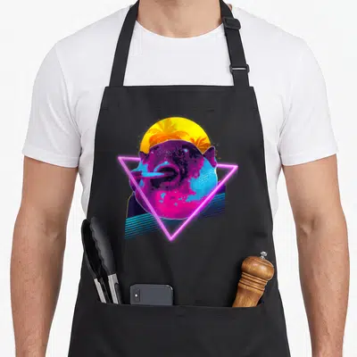 Eating meme apron - Neon pink triangle frames purple and blue hippo head against yellow sun with palm trees and blue — shown on a black cotton canvas apron against a white background