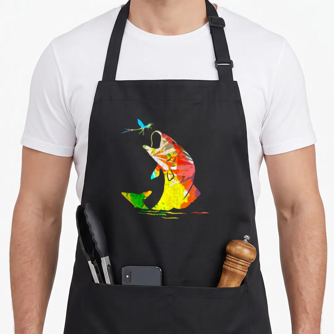 Rainbow fish apron - Watercolor multicolored fish jumping towards a blue fly — shown on a black cotton canvas apron against a white background