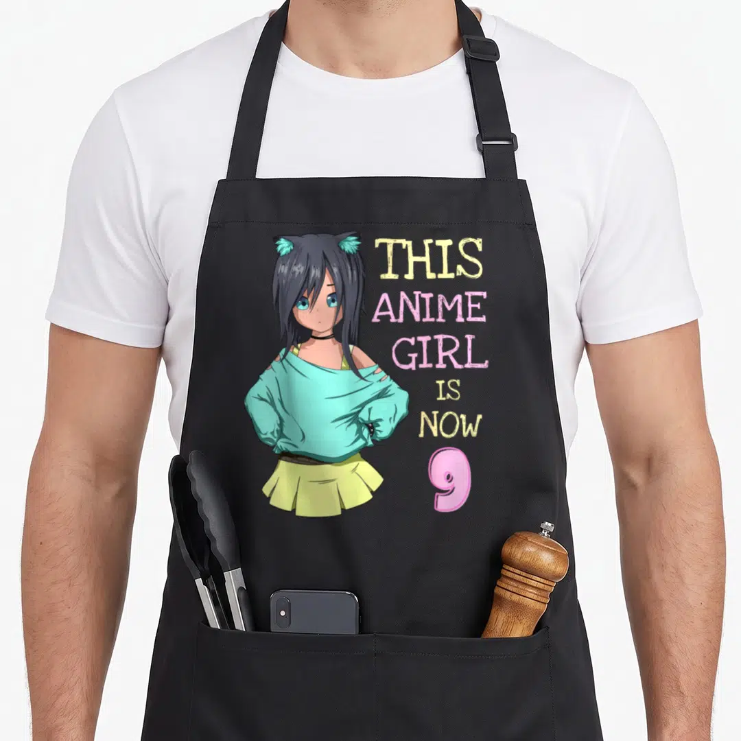 Vintage birthday anime mom apron - Anime girl with cat ears and text This Anime Girl Is Now 9 — shown on a black cotton canvas apron against a white background