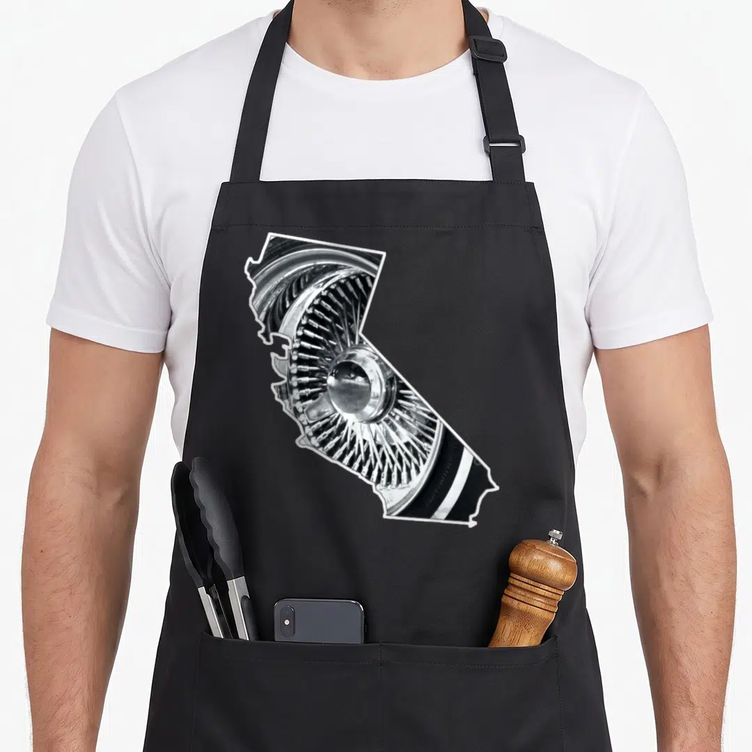 California wheel apron - Car wheel photo shaped like California state outline in silver and black — shown on a black cotton canvas apron against a white background