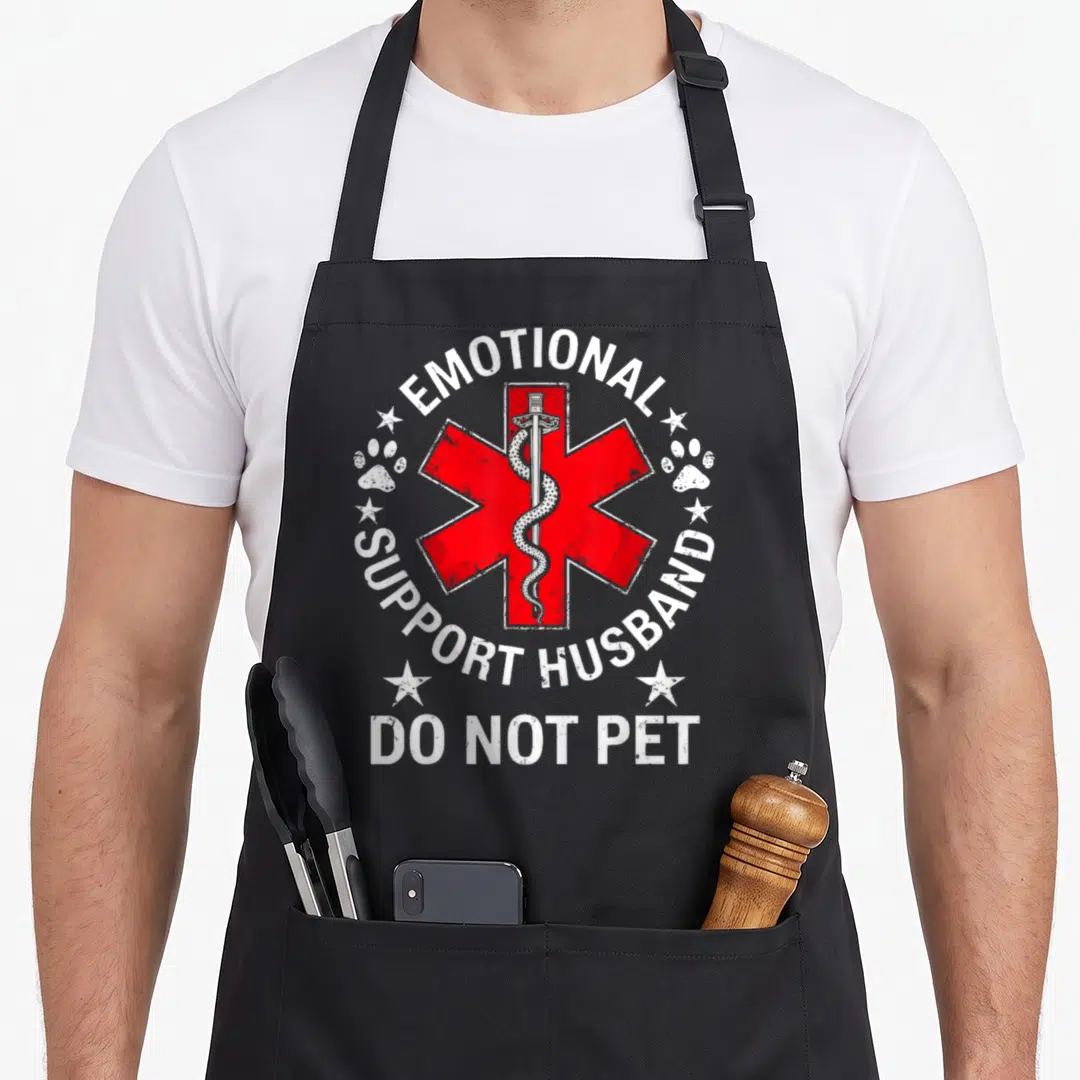 Cute emotional husband apron - Red Star of Life with snake sword and text Emotional Support Husband Do Not Pet — shown on a black cotton canvas apron against a white background