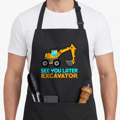 See excavator apron - Cartoon orange excavator above blue and orange text reading See You Later Excavator — shown on a black cotton canvas apron against a white background
