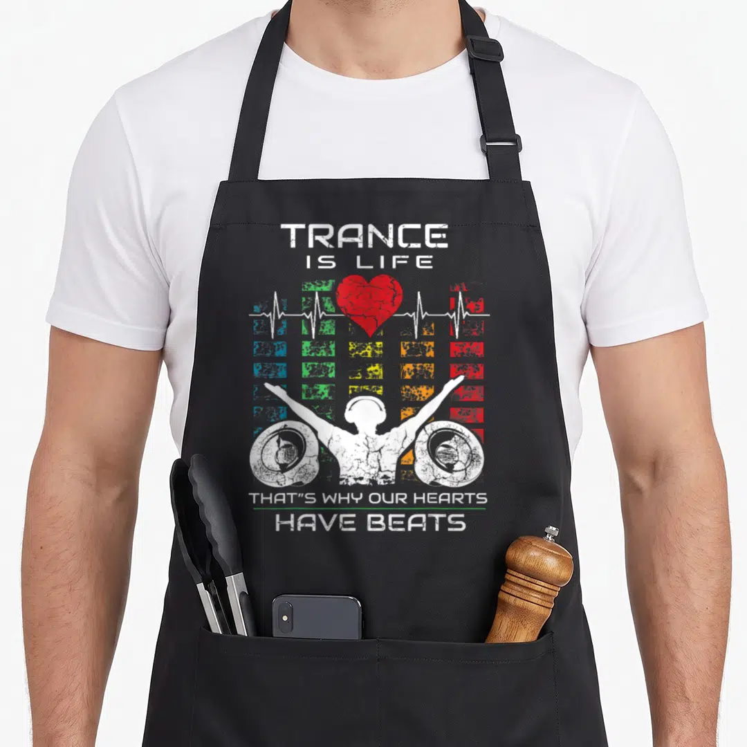 Electronic enchantments apron - Distressed Trance Is Life text DJ silhouette red heart and colored grid squares — shown on a black cotton canvas apron against a white background